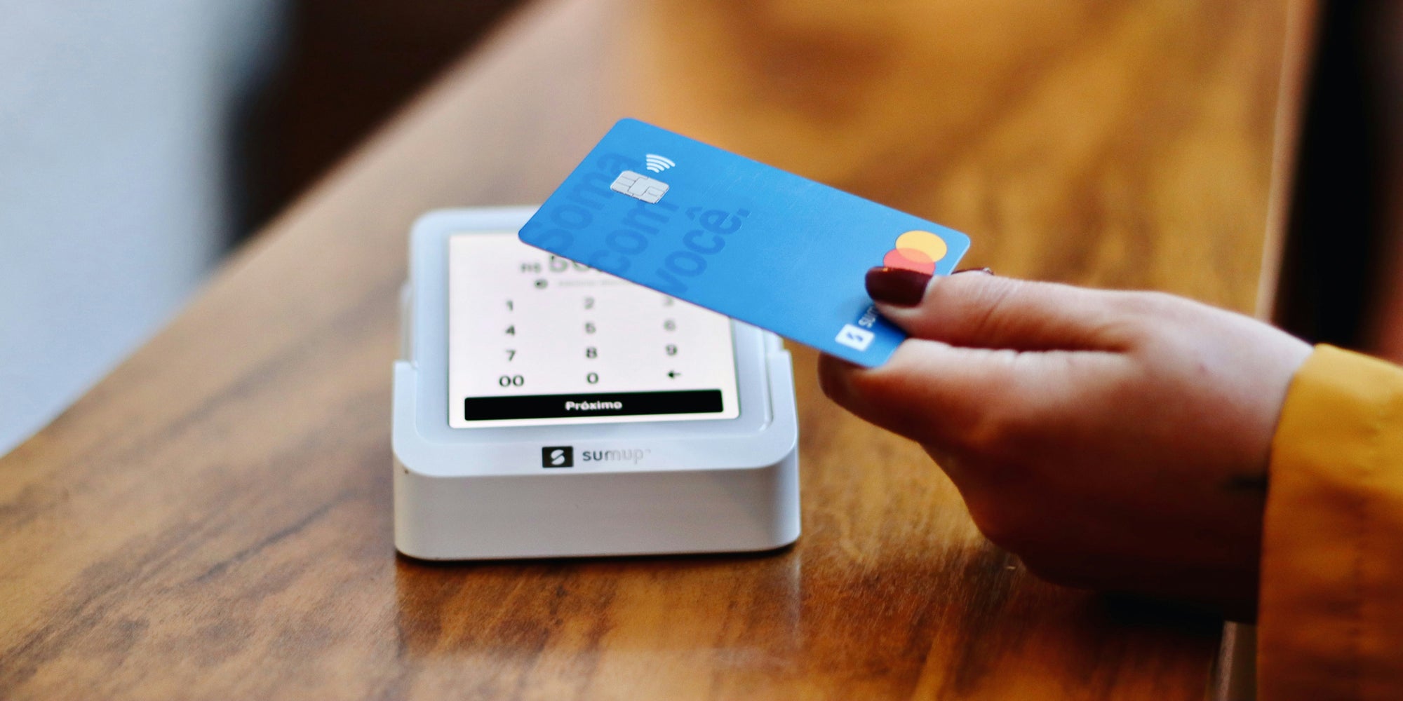 
                person using contactless payment on card reader
              