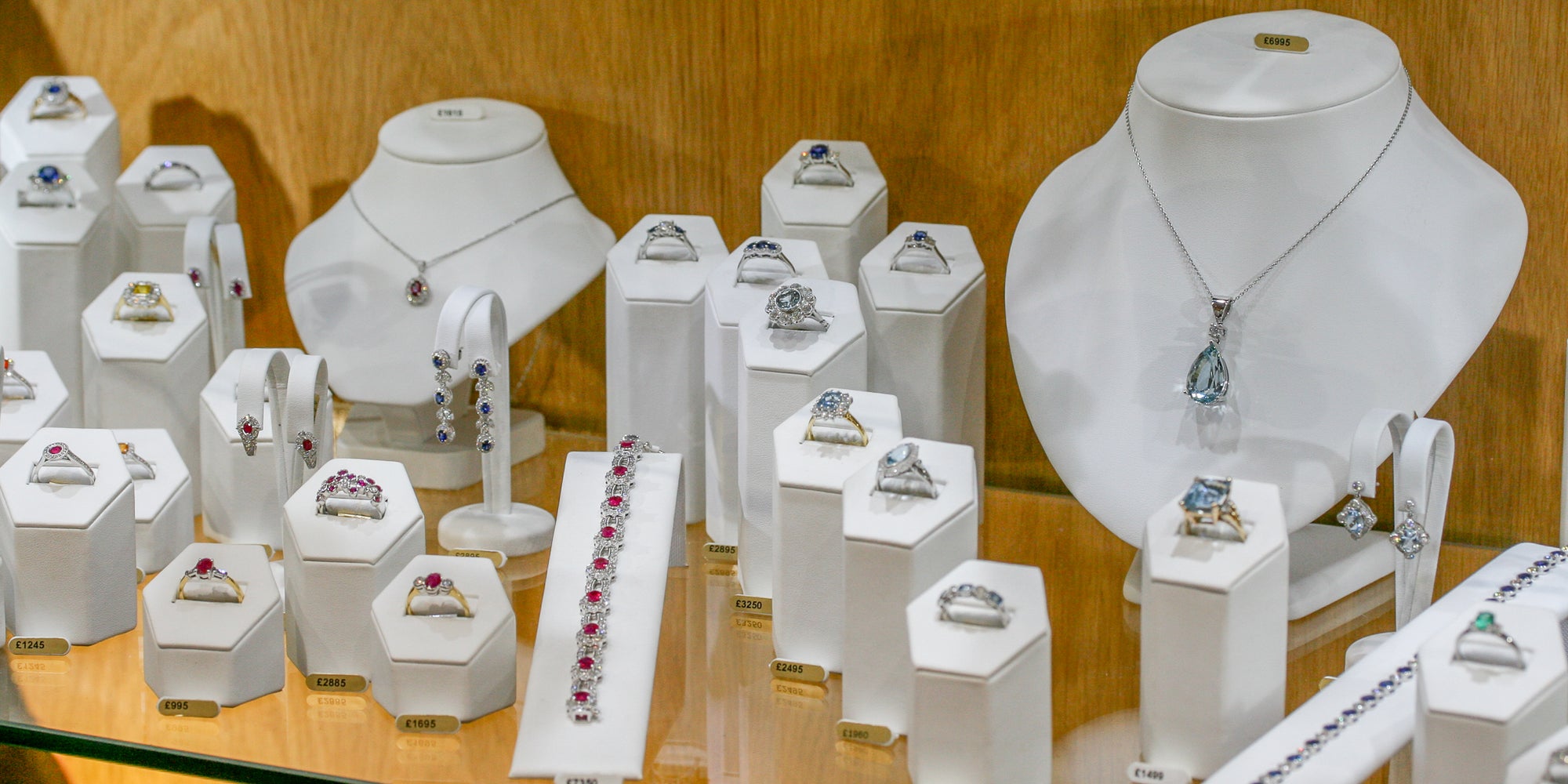 coloured jewellery on white stands