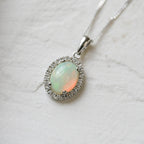 18 Carat White Gold Opal & 0.08 Carat Diamond Halo Pendant Necklace - Jordans Jewellers