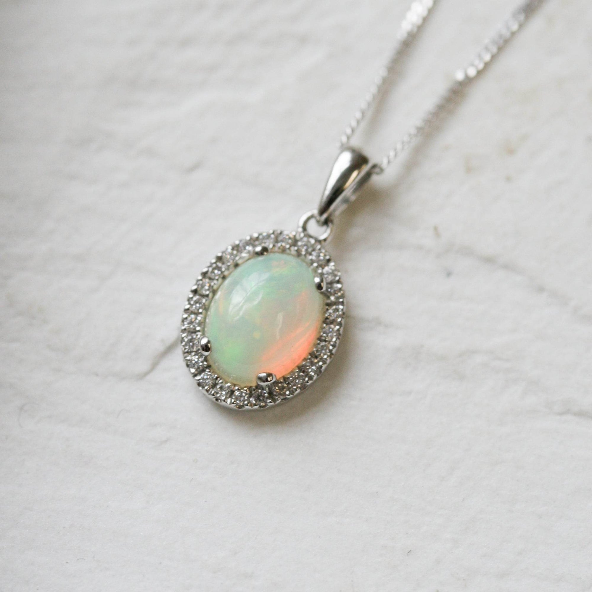 18 Carat White Gold Opal & 0.08 Carat Diamond Halo Pendant Necklace - Jordans Jewellers