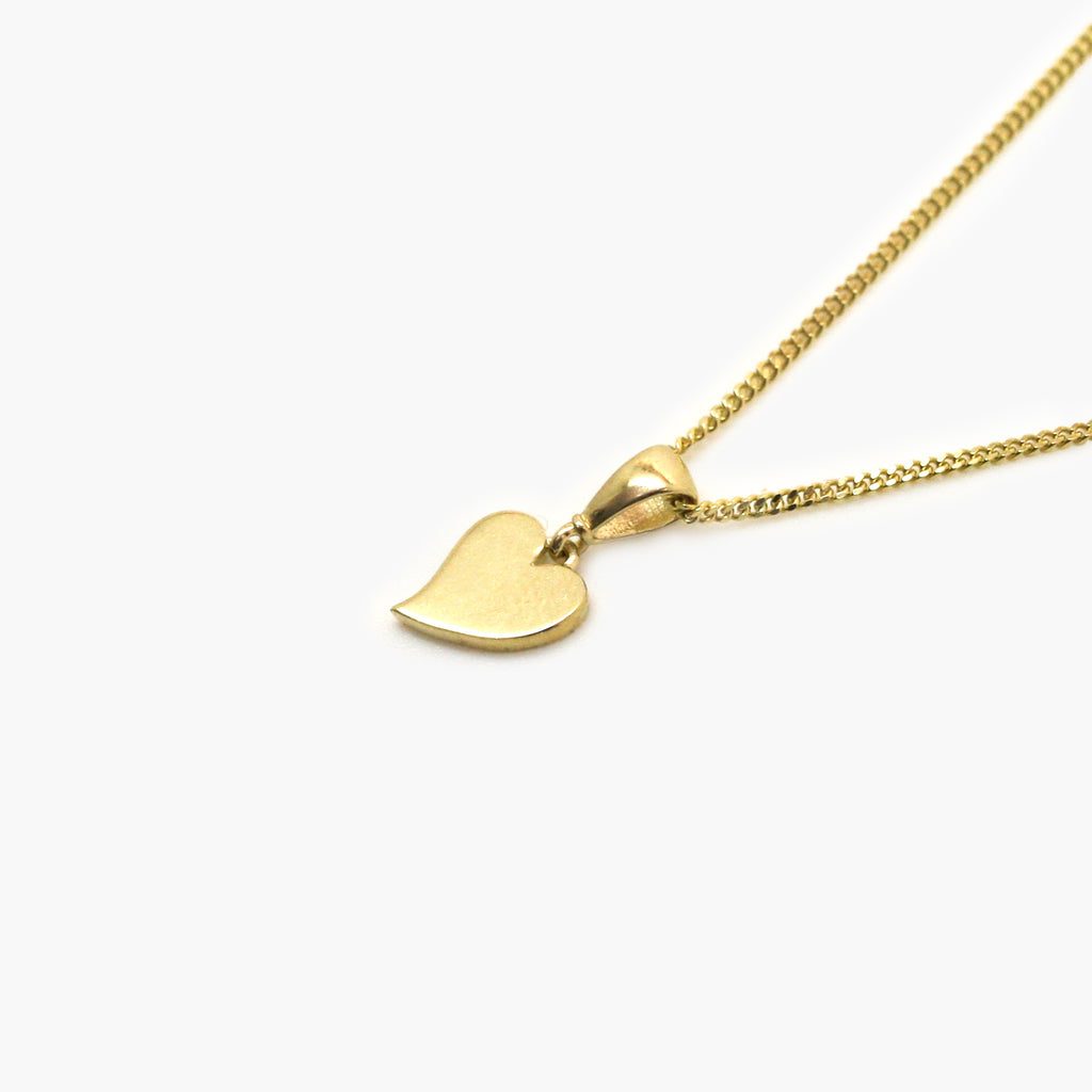 Yellow Gold Mini heart pendant necklace sitting on a white background