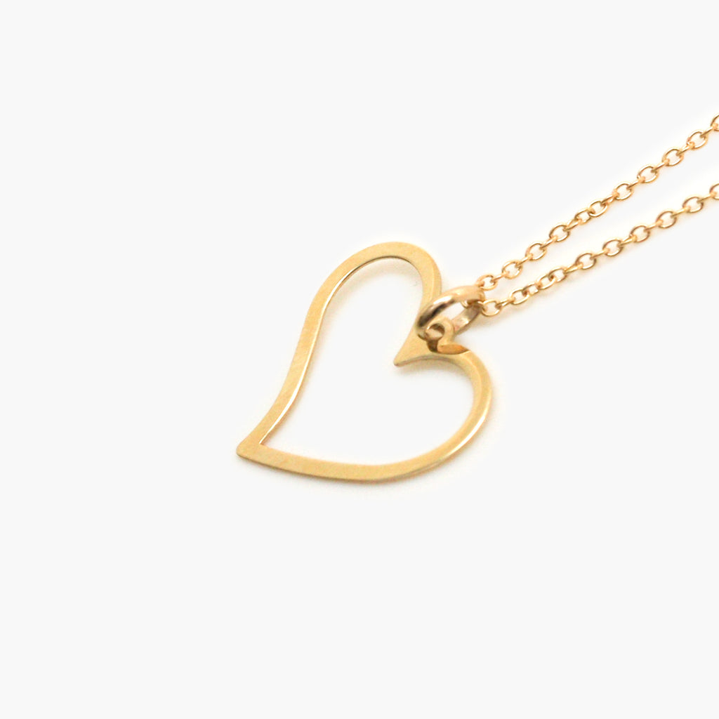 Yellow gold cut out heart 9 Carat pendant necklace on a white background