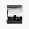 Black enamel cufflinks with a diamond in a box