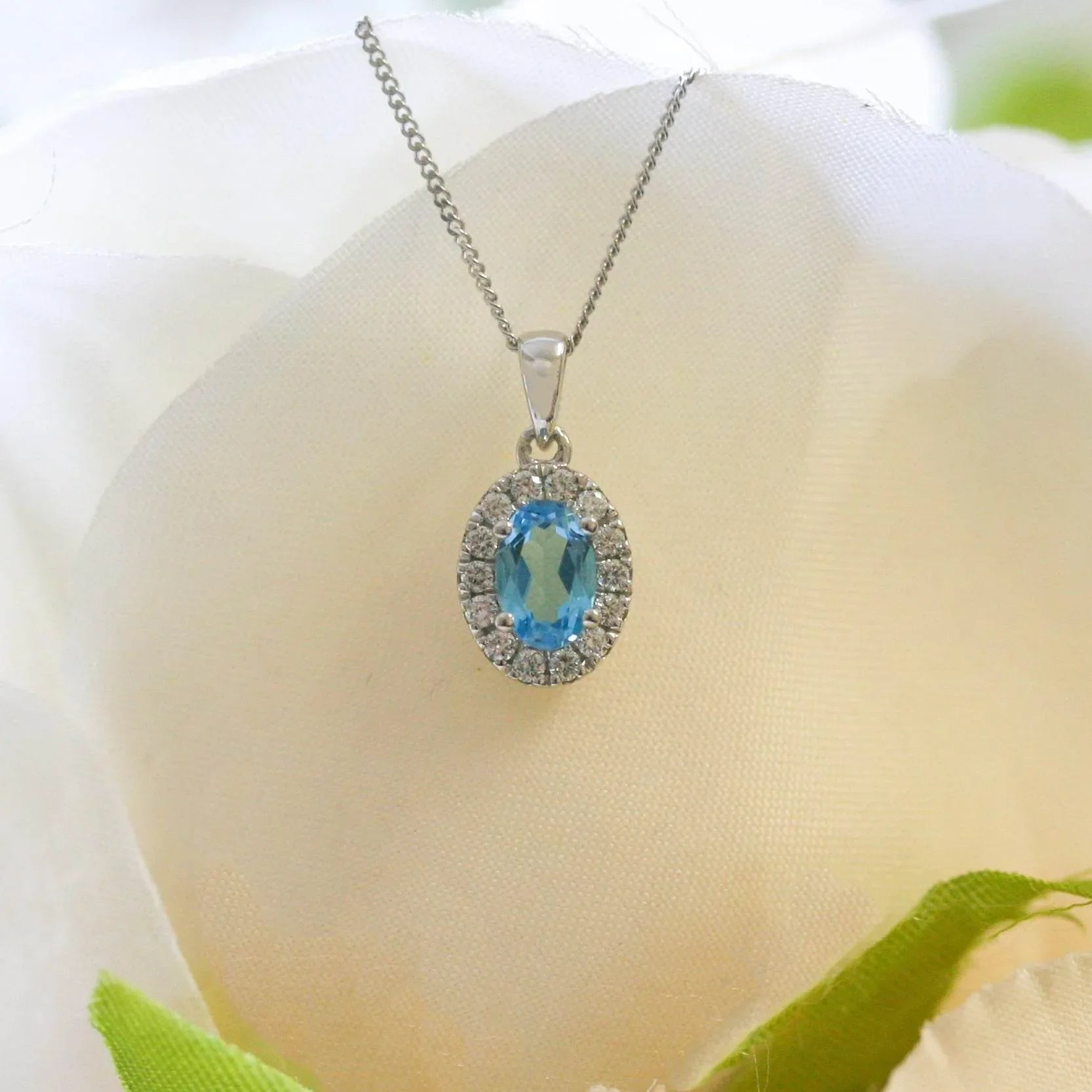 NEW 9ct White Gold Oval Blue Topaz and Diamond Cluster Pendant Necklace - Jordans Jewellers