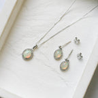 18 Carat White Gold Opal & 0.08 Carat Diamond Halo Pendant Necklace - Jordans Jewellers