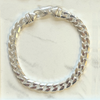 Mens silver curb bracelet on a marble background