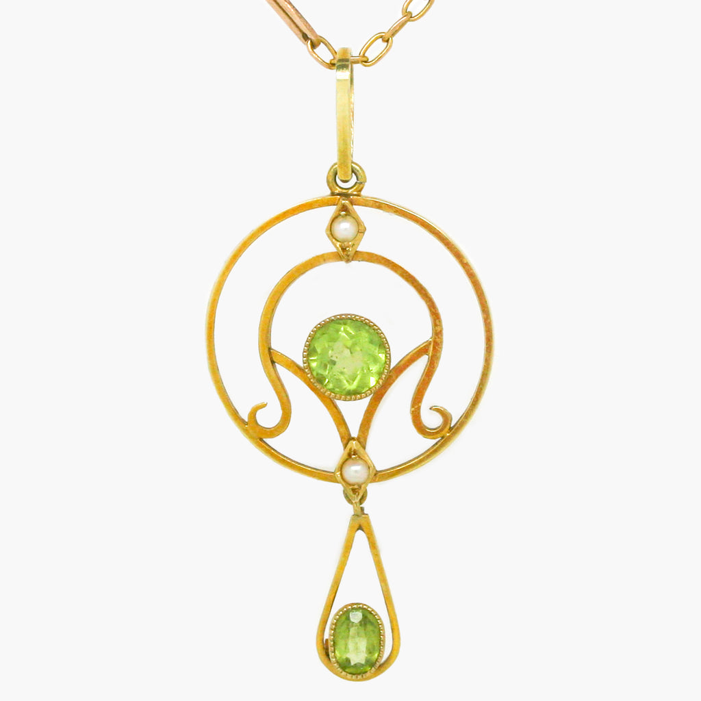 Antique peridot and seed pearl lavalier hung on a 9 carat yellow gold antique chain