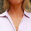 Silver drop circle ball chain necklace shot on a woman in front of a brick wall