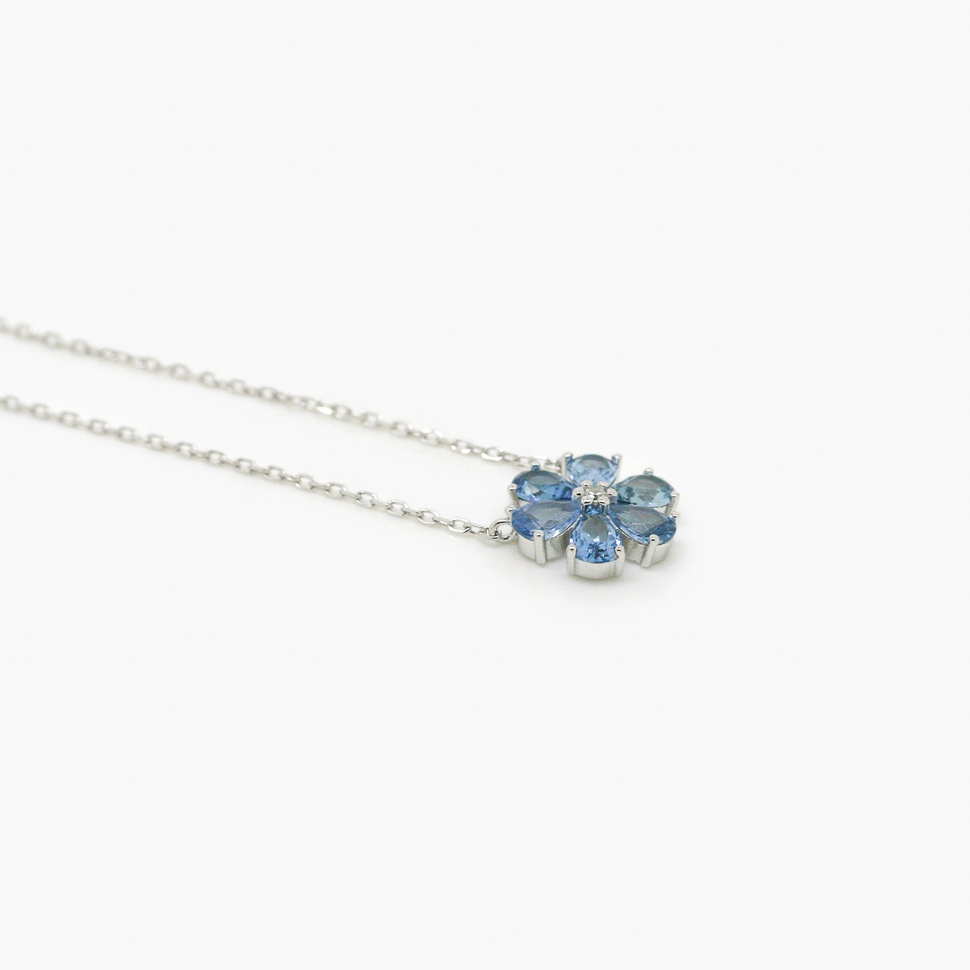 6 leaf blue cubic zirconia flower necklace with a silver trace chain