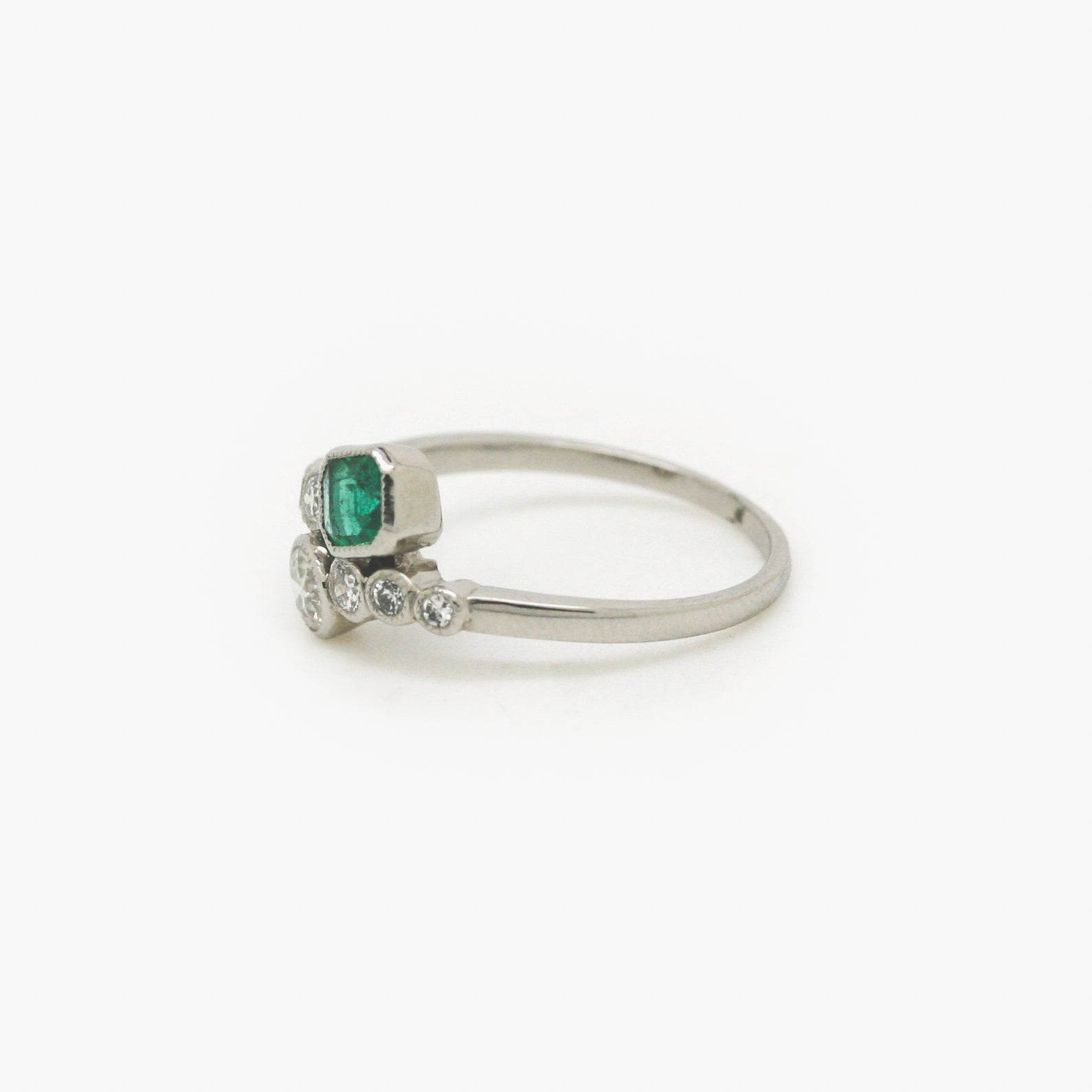 Emerald and Diamond Crossover Ring set in Platinum - Jordans Jewellers