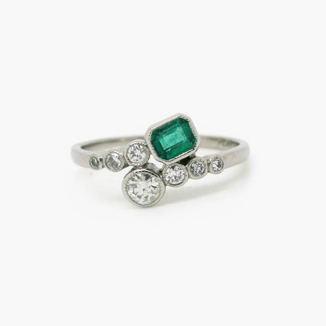 Emerald and Diamond Crossover Ring set in Platinum - Jordans Jewellers