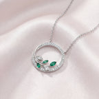 9ct White Gold Emerald and Diamond Circle Pendant Necklace - Jordans Jewellers