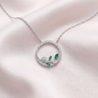 9ct White Gold Emerald and Diamond Circle Pendant Necklace - Jordans Jewellers