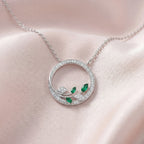 9ct White Gold Emerald and Diamond Circle Pendant Necklace - Jordans Jewellers