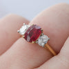 0.8x0.6cm Oval Ruby & Diamond Trilogy Ring - close up on hand