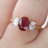 0.8x0.6cm Oval Ruby & Diamond Trilogy Ring - close up on hand